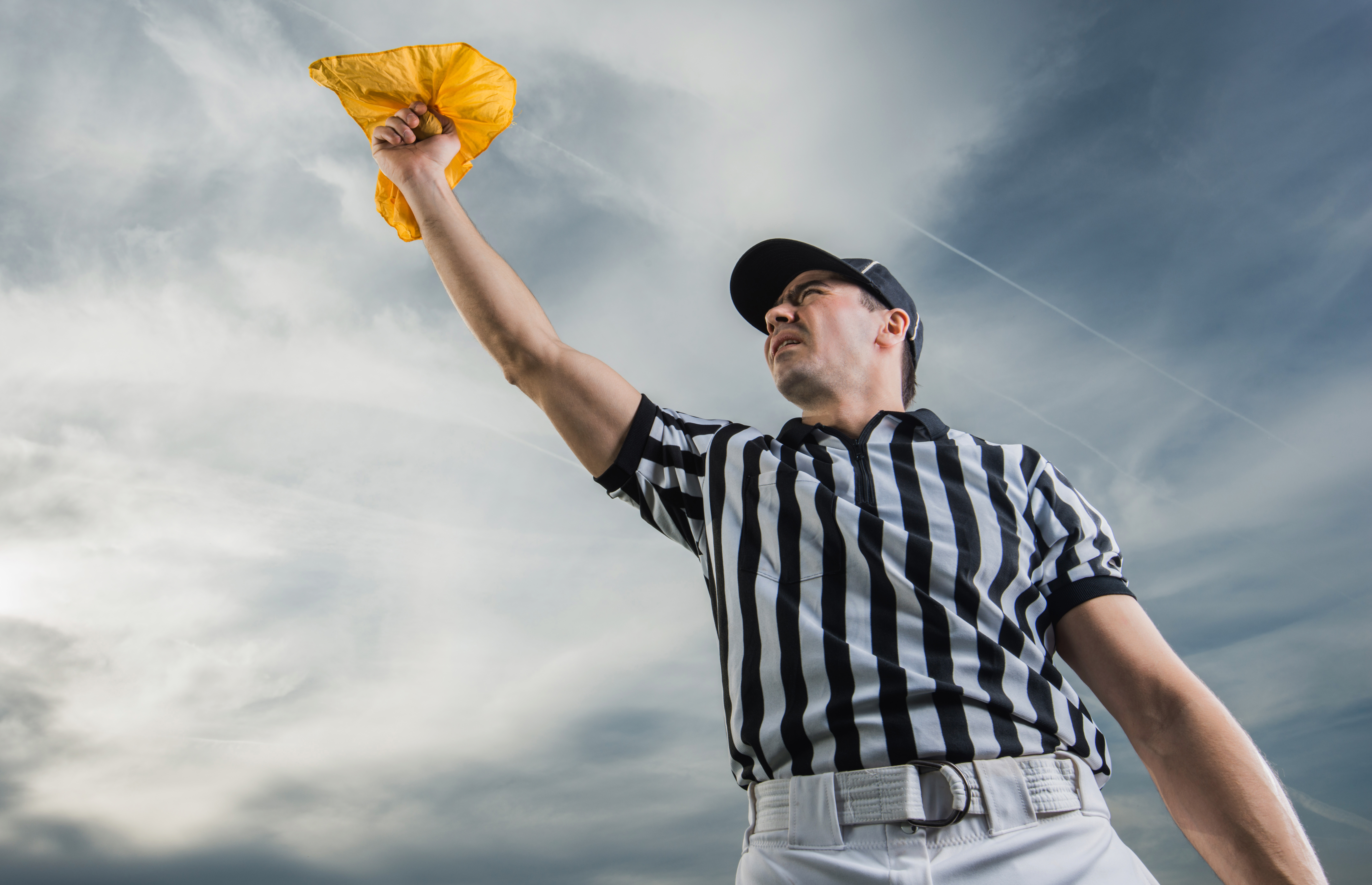 Referee holding up a yellow flag