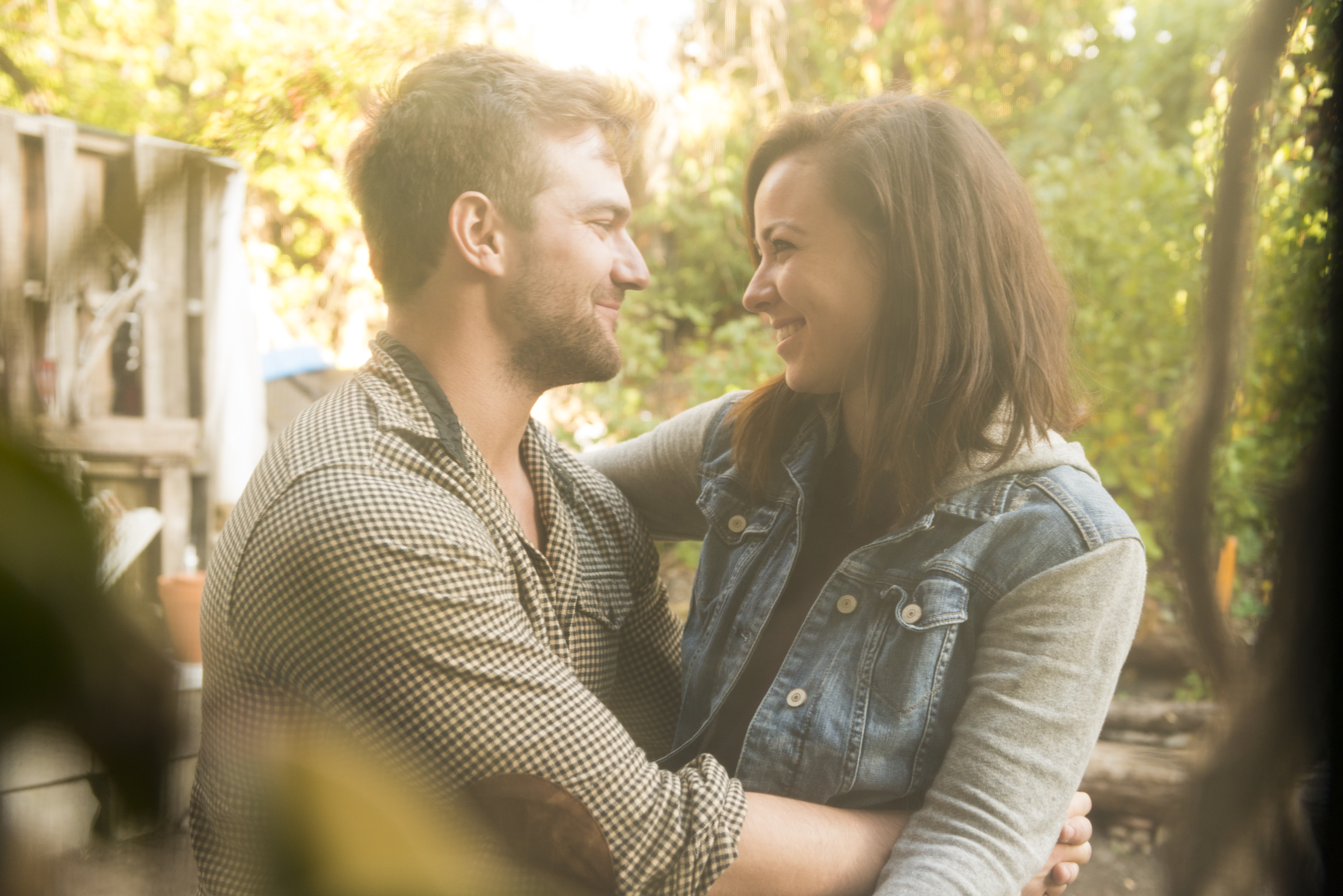 Couples looking into each others eyes while in a hug