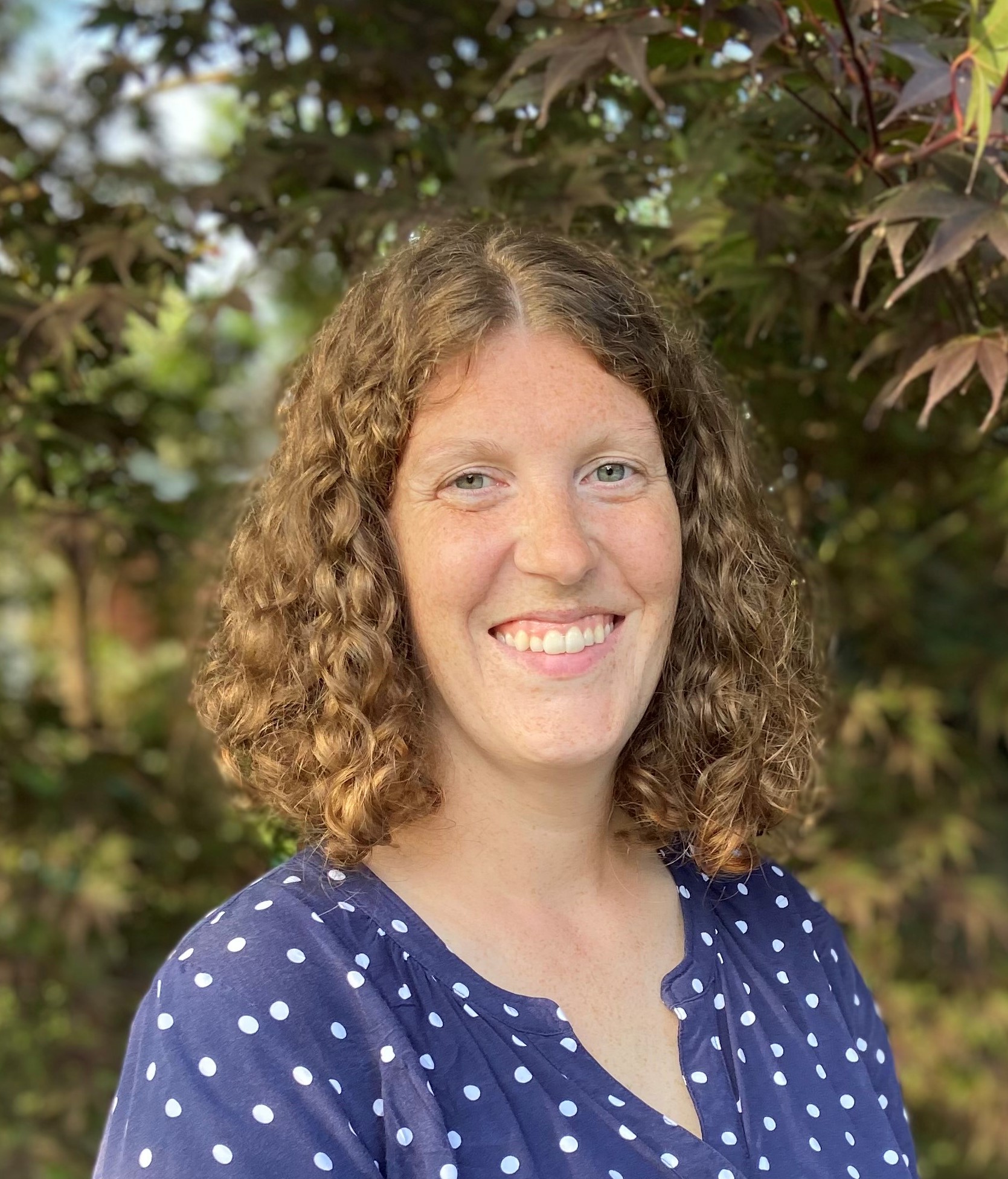 woman with curly hair smiling