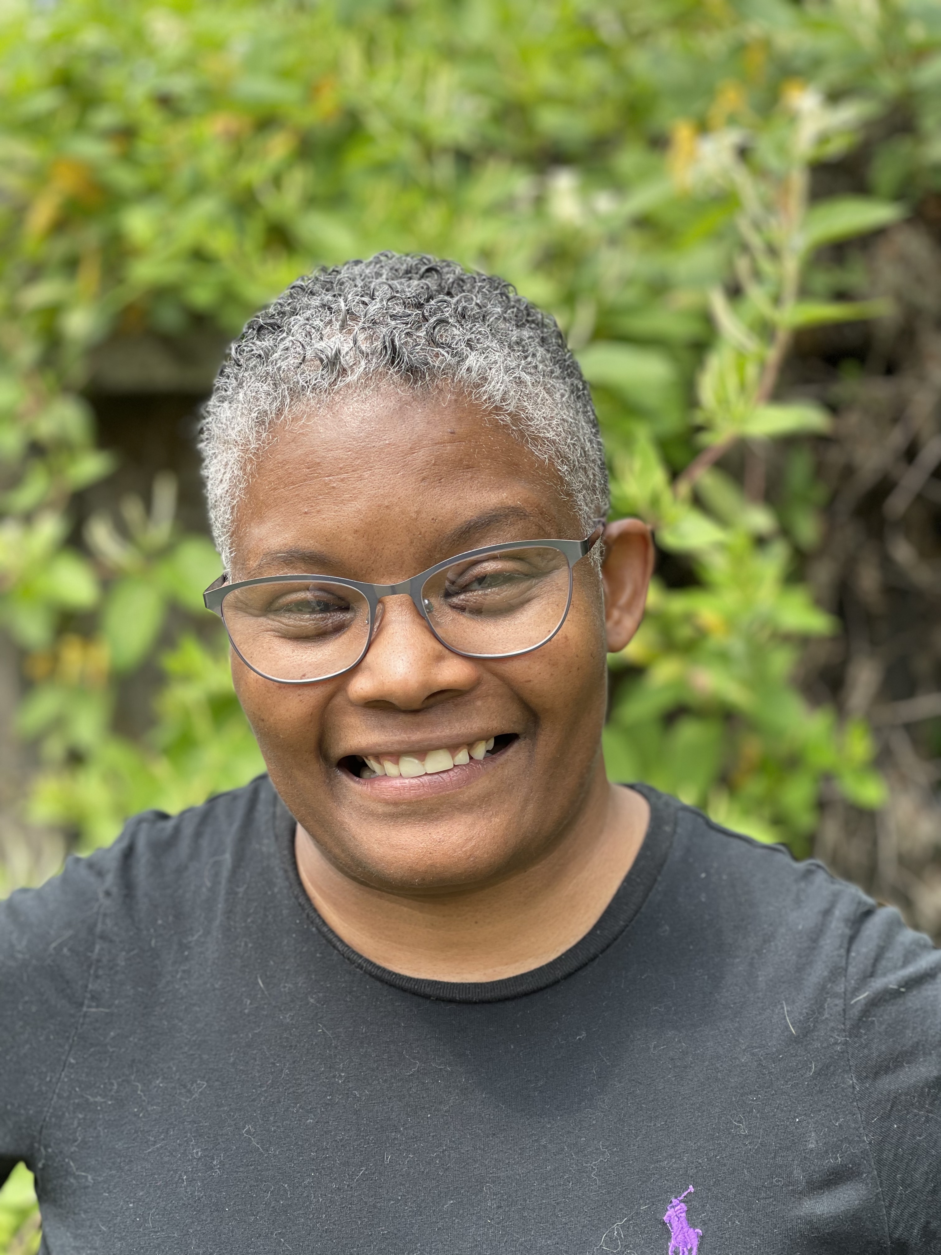 Woman with black shirt and short curly hair
