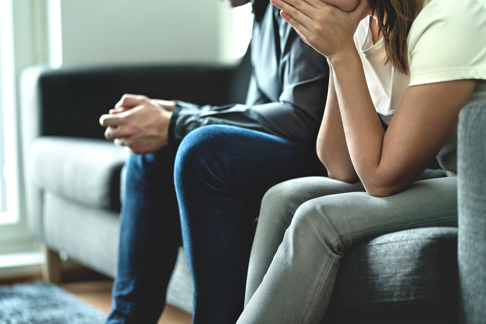 A couple sits next to each other. This relates to concepts of marriage counseling in St. Louis, MO. Our marriage counselors in St. Louis, MO can help through marriage counseling in St. Louis, MO.
