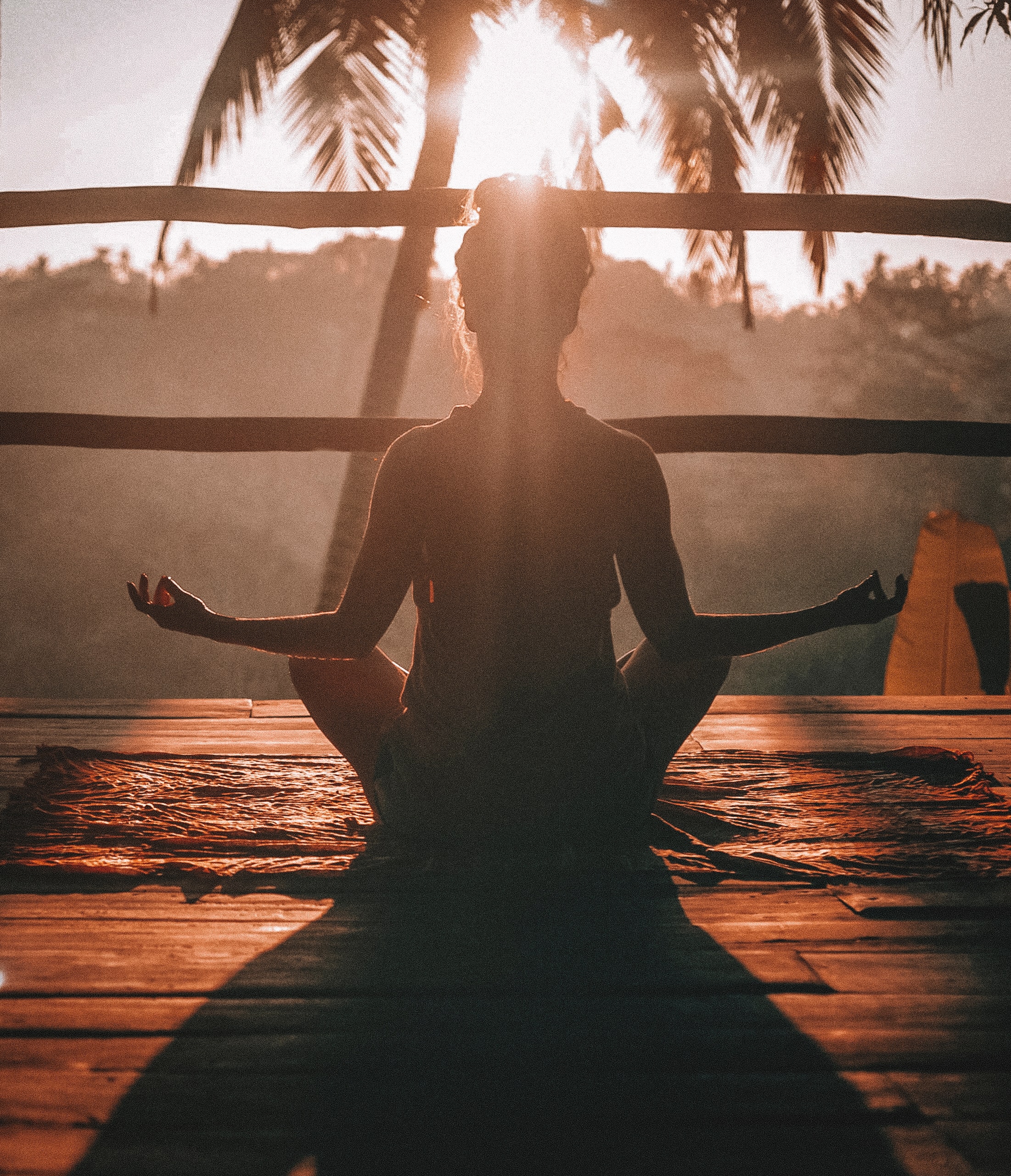 Woman meditating at sunrise