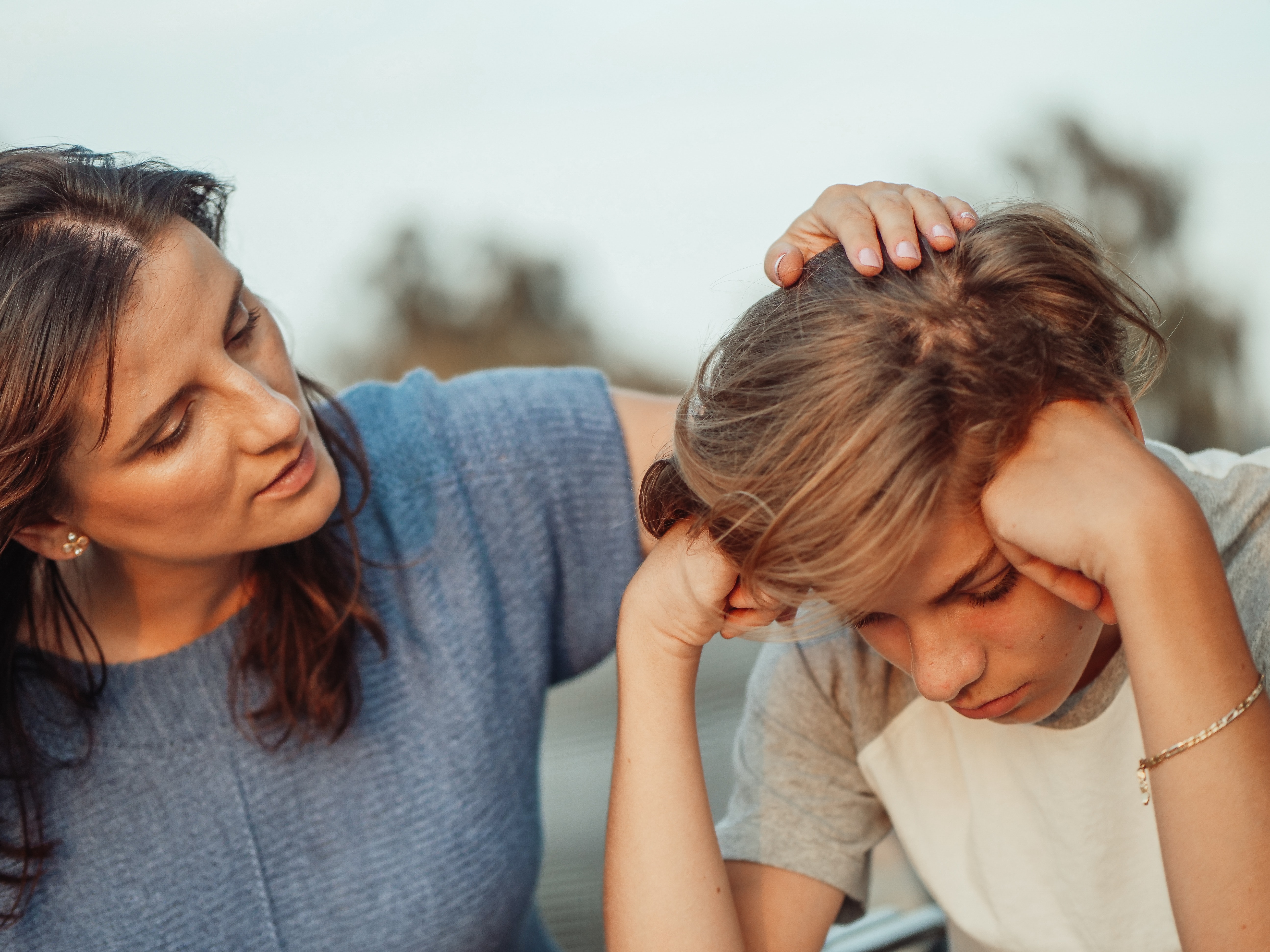 A mother comforts her son experiencing depression and anxiety in St. Louis, Missouri