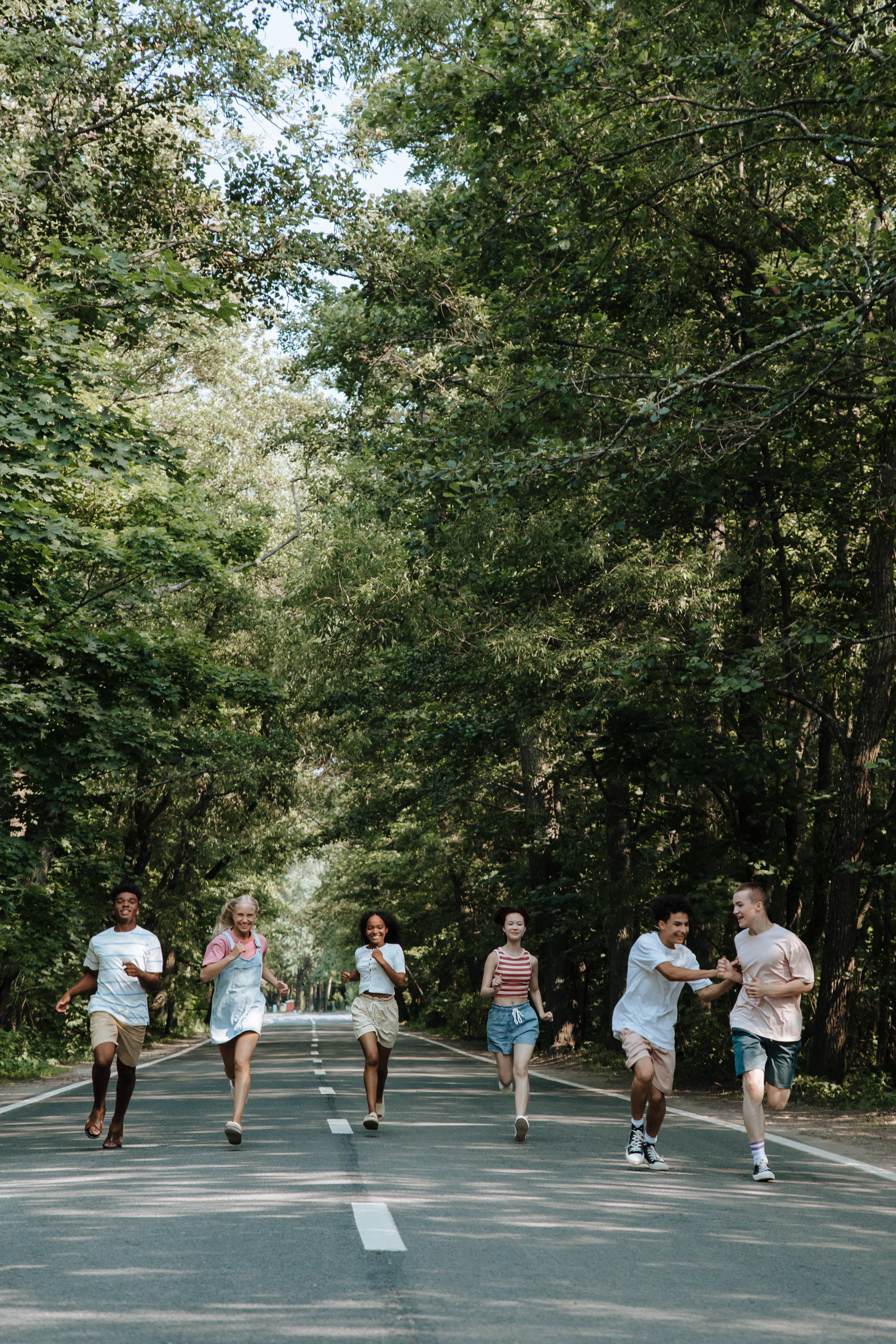 Teenagers running happily down the street