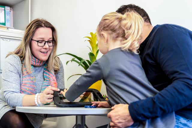 A child sits with two adults. It appears this child is partaking in child therapy in St. Louis, MO. Working with a child therapist in St. Louis, MO can help your child thrive, especially through play therapy in St. Louis, MO. Learn more about child therapy in St. Louis, MO.