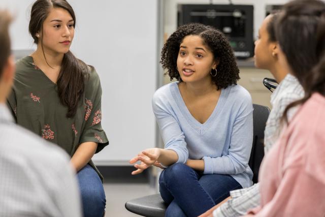 Teens discussing issues in mental health group therapy