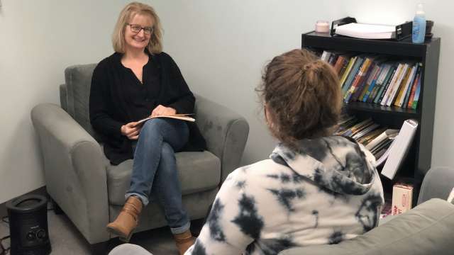 Susan Walsh, St. Louis Therapist. Woman with glasses smiling