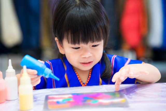 A young girl smiles while painting. This demonstrates activities that happen during play therapy in St. Louis, MO. Child therapy in St. Louis, MO can be a beneficial option for your child. Speak to our child therapists in St. Louis, MO to learn more about play therapy in St. Louis, MO.