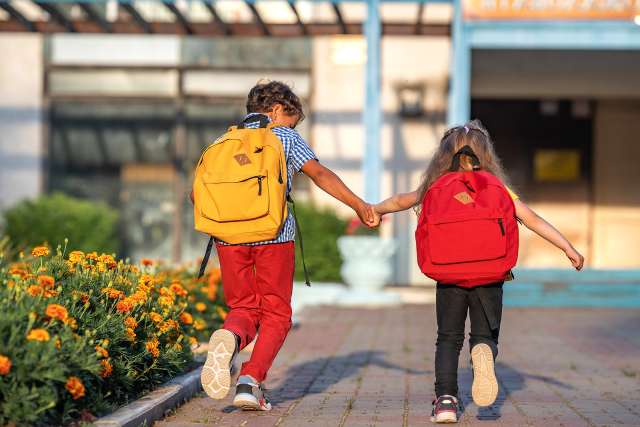 Two children walk into school appearing happy. Happiness can be fostered through child therapy in St. Louis, MO. Our child therapists in St. Louis, MO offer play therapy and CBT for kids. Learn more about the services we offer for child therapy in St. Louis, MO