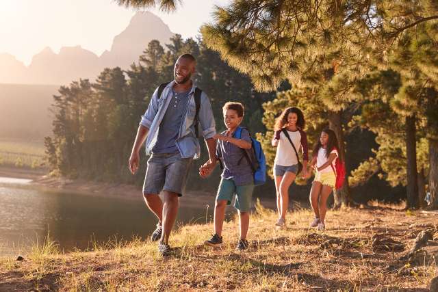 A family walks by a lake. This is related to child therapy in St. Louis, MO. Our child therapist in St. Louis, MO can address conflicts in your family.