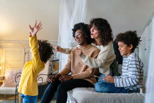 A family sits together. This relates to aspects of child therapy in St. Louis, MO. Our child therapists in St. Louis, MO can help your kids fight less. 