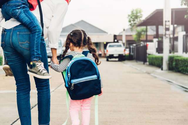 A child is shown walking into school. This relates to concepts of child therapy in St. Louis, MO. Our child therapists in St. Louis, MO can help your child.