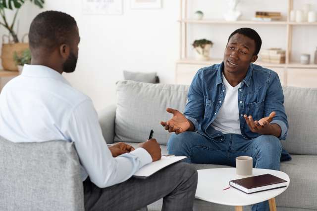 A man sits in a therapy session. This reflects concepts of therapy in St. Louis, MO. Our therapist in St. Louis, MO offer effective therapy in St. Louis, MO.