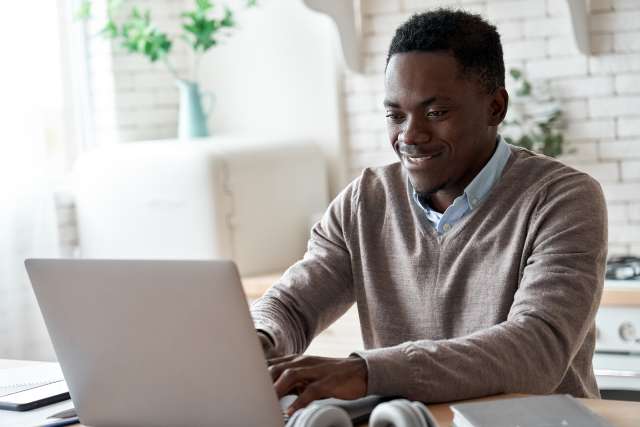 A man is using a computer. This relates to concepts of trauma therapy in Lees Summit, MO. Our trauma therapist in Lees Summit, MO offer online therapy in Kansas City, MO. 