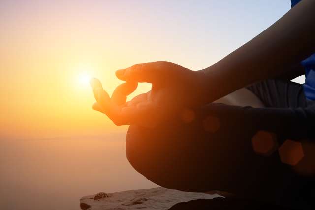 A woman is meditating. This relates to concepts of therapy in St. Louis, MO. Our therapists in St. Louis, MO can offer online therapy in Kansas City, MO.