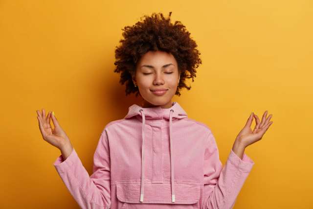 Woman in lotus position getting back to happy after psychiatry and talk therapy.