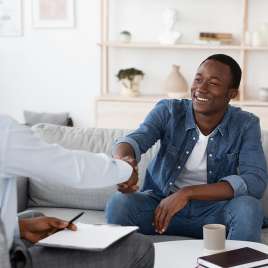 A man shakes the hand of another man. This relates to topics of therapy in St. Louis, MO. Our therapists in St. Louis, MO provide effective in person therapy and online therapy in Missouri.