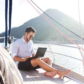 A man smiles on a boat. This reflects concepts of online therapy in Missouri. Online therapy in Missouri brings you effective therapy with an online therapist. 