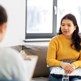 A woman sits in an office. This demonstrates concepts of therapy in St. Louis, MO. Our therapist in St. Louis, MO provide in-person and online therapy. 