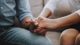 Couple holding hands in therapy