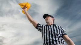 Referee holding up a yellow flag