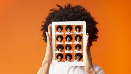 Photo with woman holding up different versions of herself on a screen