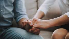 two people holding hands on a knee