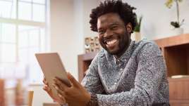 A man holds an ipad. This relates to online therapy in Missouri. Our online therapist in Missouri provide effective treatment through online therapy.
