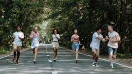 Teenagers running happily down the street